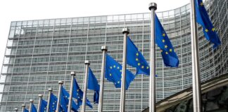 European Union Flags Waving In Brussels Opposite The European Commission Building