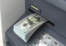 An ATM accepts a deposit of US dollar bills