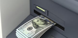 An ATM accepts a deposit of US dollar bills