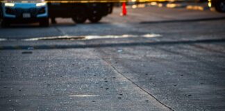 shattered glass on a roadway from a shootout