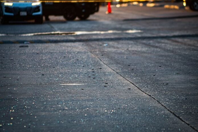shattered glass on a roadway from a shootout