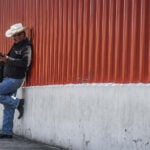 A Mexico City man checks his phone outside the San Lazaro Legislative Palace.