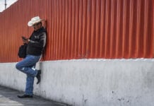 A Mexico City man checks his phone outside the San Lazaro Legislative Palace.
