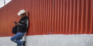 A Mexico City man checks his phone outside the San Lazaro Legislative Palace.