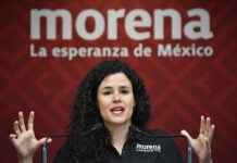 Morena Party President Luisa María Alcalde at a podium in front of a Morena banner