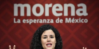 Morena Party President Luisa María Alcalde at a podium in front of a Morena banner