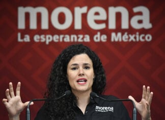 Morena Party President Luisa María Alcalde at a podium in front of a Morena banner
