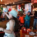 Patrons of a bar celebrate a World Cup match