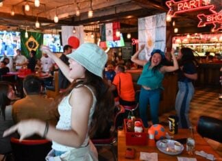 Patrons of a bar celebrate a World Cup match