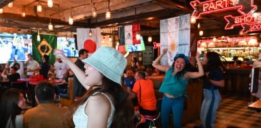 Patrons of a bar celebrate a World Cup match