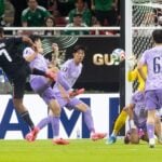 Luis Romo pushes the soccer ball though a tangle of four South Korean defenders, into the goal