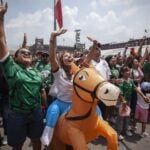 Mexican fans celebrate in a FIFA Fan Fest