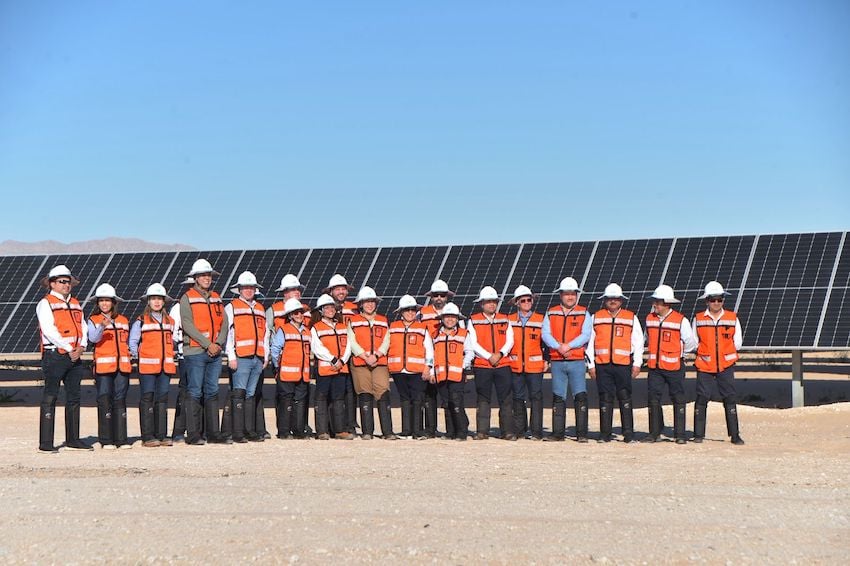 workers stand before the Rafael Galván Maldonado Solar Farm in Puerto Peñasco, Sonora