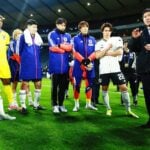 Members of the Japanese men's national team lined up together on a pitch