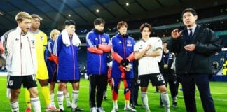 Members of the Japanese men's national team lined up together on a pitch