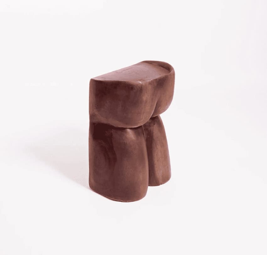 A wooden chair sculpted to look like a human behind and thighs.