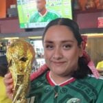 Woman holding FIFA World Cup trophy in a Puerto Vallarta restaurant