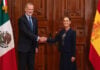 King Felipe VI of Spain's shakes hands with President Sheinbaum, posing with Spanish and Mexican flags