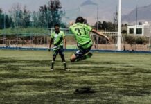 Teenagers playing football on a pitch in Oaxaca