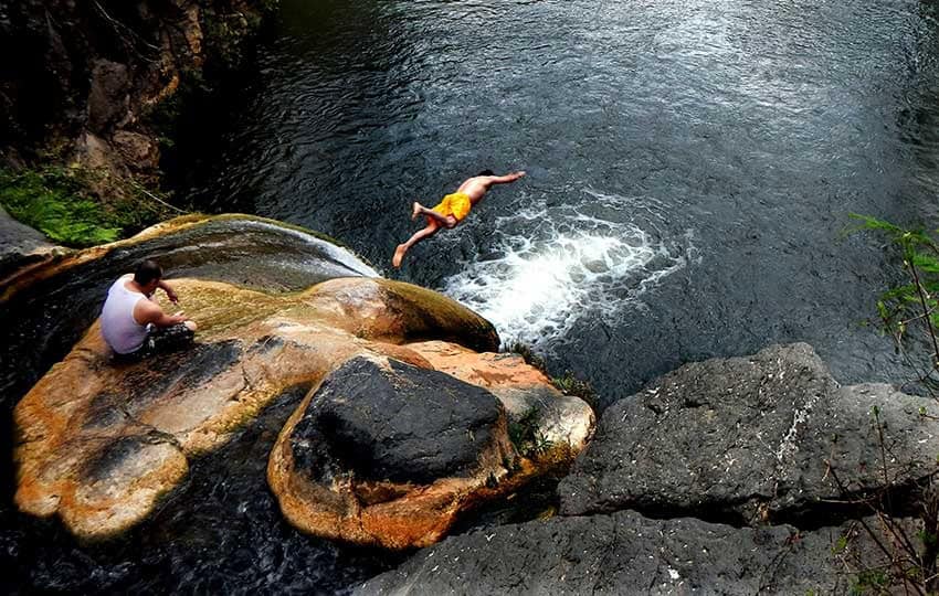 Comala Falls waterfall, with a diver leaping from the rocks
