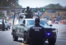 Police standing in front of a road closure