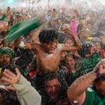 Mexico fans celebrating in the rain after a World Cup victory over Ecuador