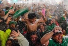 Mexico fans celebrating in the rain after a World Cup victory over Ecuador