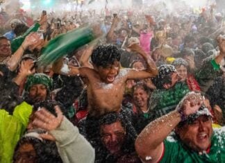 Mexico fans celebrating in the rain after a World Cup victory over Ecuador
