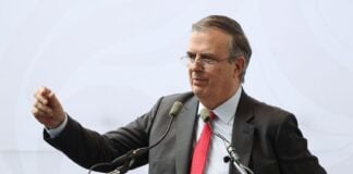 Ebrard at podium