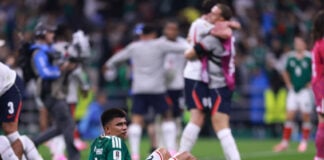 A Mexican player sits down on the field after losing in the World Cup round of 16 while England players hug in celebration