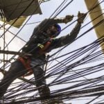 CFE technician working on an electric pole