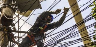 CFE technician working on an electric pole