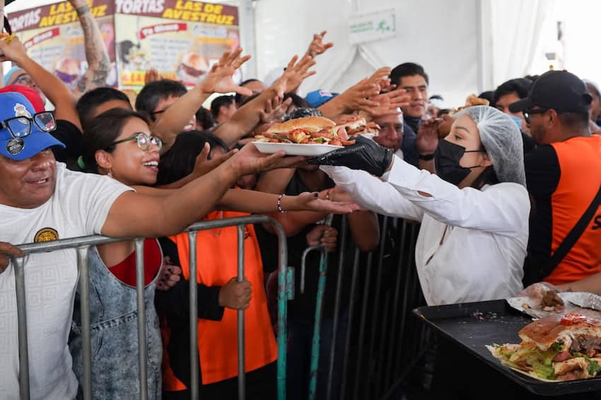servers hand portions of the Guinness record winning torta to the public