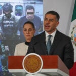 Security Minister Omar García Harfuch discusses the arrest of "R1," alleged mastermind of Mayor Carlos Manzo's murder, at the July 31 mañanera as President Sheinbaum looks on