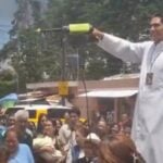 priest spraying holy water
