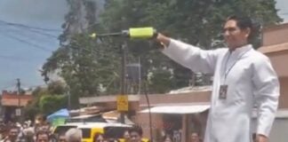 priest spraying holy water