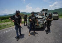 Jalisco New Generation Cartel (CJNG) fighters with an improvised armored vehicle in Aguililla, Michoacán in 2021.