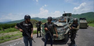 Jalisco New Generation Cartel (CJNG) fighters with an improvised armored vehicle in Aguililla, Michoacán in 2021.