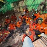 A group of Topo Azteca rescue brigade members on a pile of rubble from a collapsed building