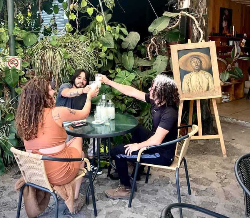 Pulquimia pulqueria in Tepoztlán with three drinkers saluting each other