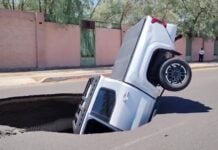 a sinkhole swallowing a pickup truck