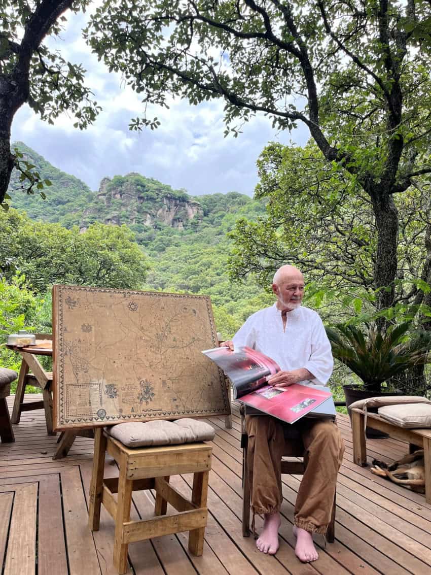 Diego Villaseñor inAmatlán de Quetzalcóatl, Morelos, showing books filled with his various architectural designs