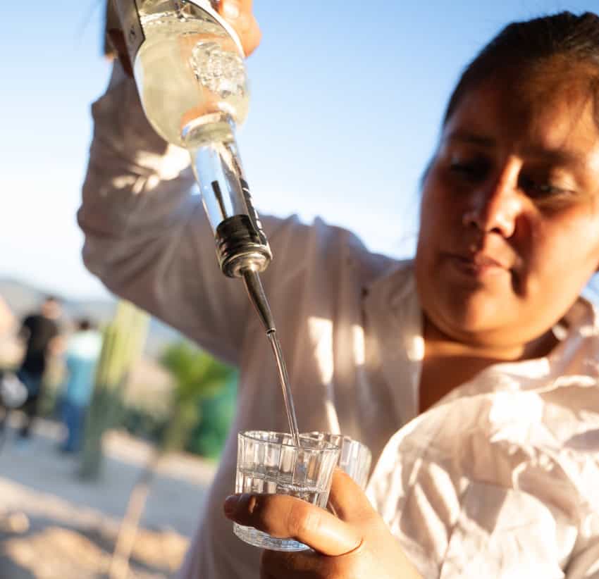 Oaxaca producer pouring mezcal at the Feria del Mezcal