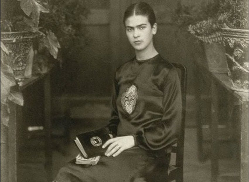 Frida Kahlo, aged 18 or 19, with a book on her lap