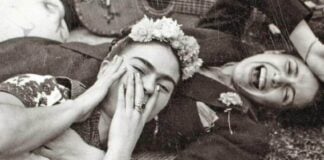 Chavela Vargas and Frida Kahlo laying and laughing together