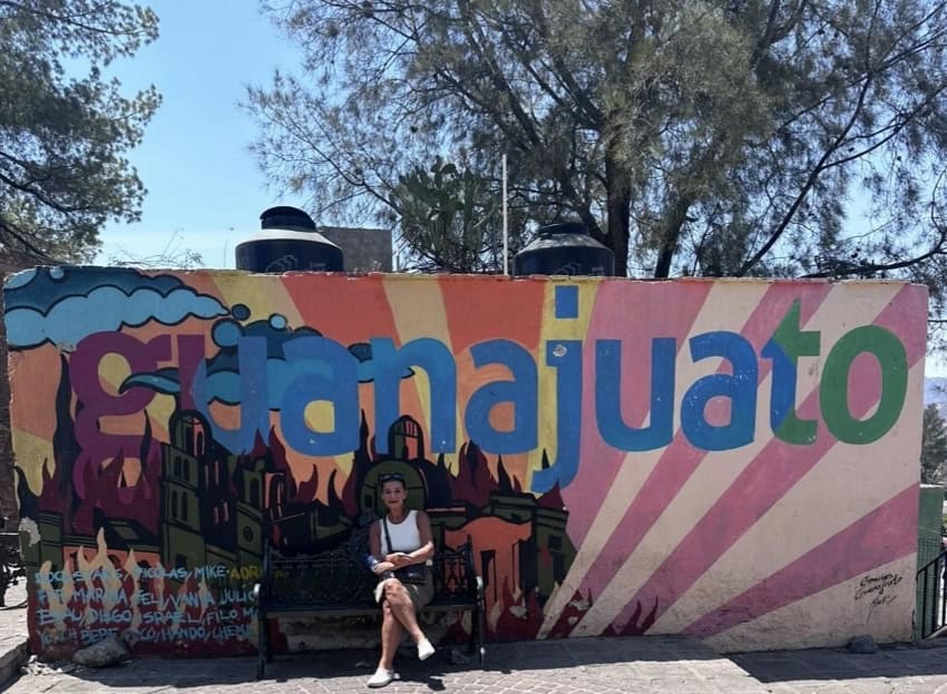 Guanajuato city mural with bench in front