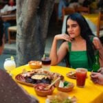 Three friends eating Mexican food in an outdoor restaurant