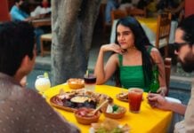 Three friends eating Mexican food in an outdoor restaurant