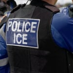 An agent with a jacket reading "Police ICE"