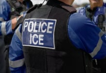An agent with a jacket reading "Police ICE"